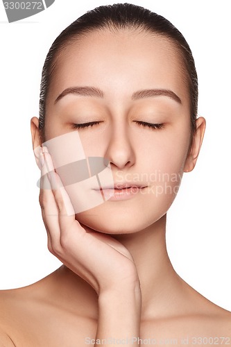 Image of Portrait of beautiful girl stroking her face with healthy skin 