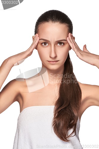 Image of Beautiful young woman with headache touching her temples