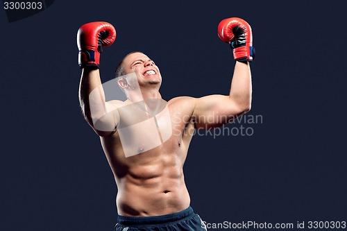 Image of Portrait of a boxer champion enjoying his victory. Studio shot.