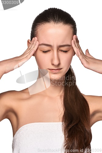 Image of Beautiful young woman with headache touching her temples