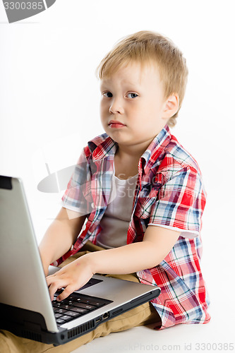 Image of child with a laptop. studio