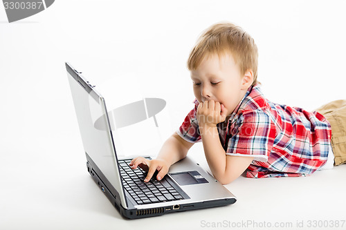 Image of child with a laptop. studio