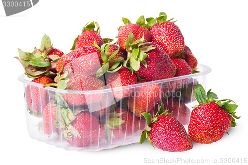 Image of Freshly strawberries in a plastic tray and two near rotated