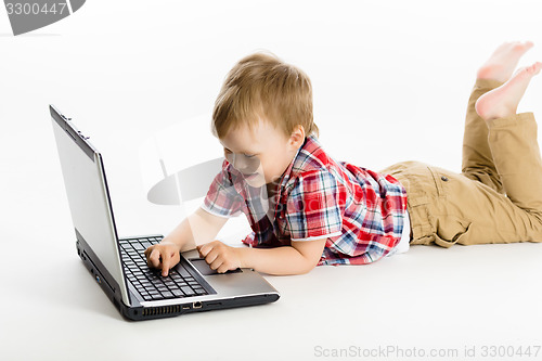 Image of child with a laptop. studio