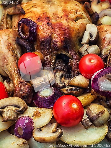 Image of baked whole chicken in vegetables