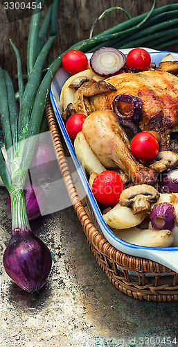 Image of baked whole chicken in vegetables