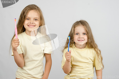 Image of Two girls with toothbrushes