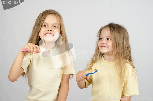 Image of Two sisters with toothbrushes