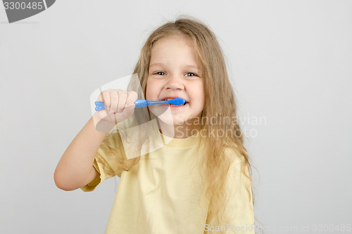 Image of Four-year girl brushing her teeth