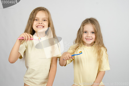 Image of Two girls are preparing to brush teeth