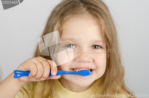 Image of Happy little girl brushing her teeth