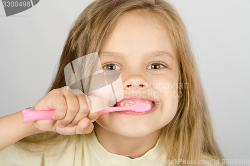 Image of Six year old girl brushing her teeth