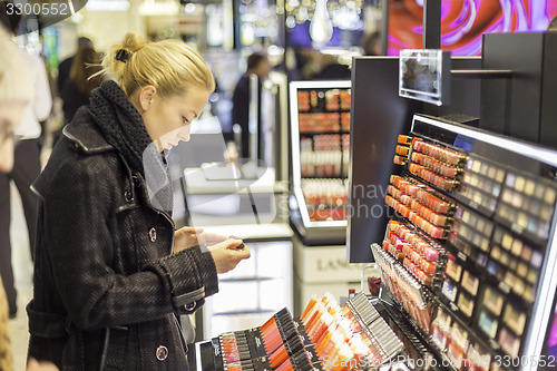 Image of Beautiful woman shopping in beauty store.