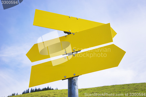 Image of Three yellow empty arrow signs 