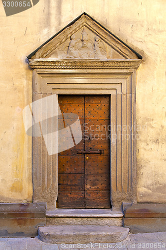 Image of door   in italy  lombardy   downhill road church    