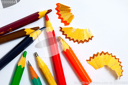 Image of several vintage pencils and shavings on white