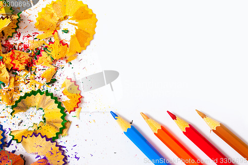 Image of colored pencils and shavings on white background