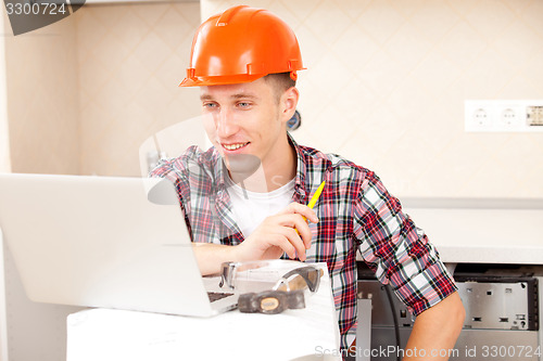 Image of workers with a laptop