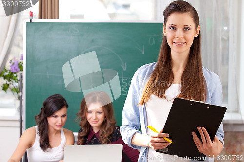 Image of smiling  girl looking at camera in college