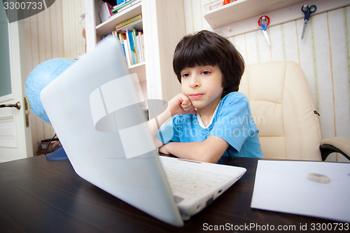 Image of boy with computer, distance learning