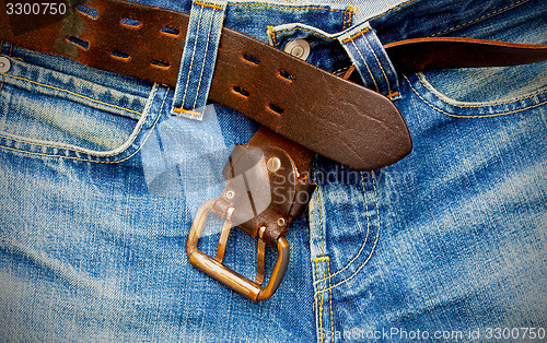 Image of leather belt on old jeans