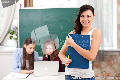 Image of smiling  girl looking at camera in college