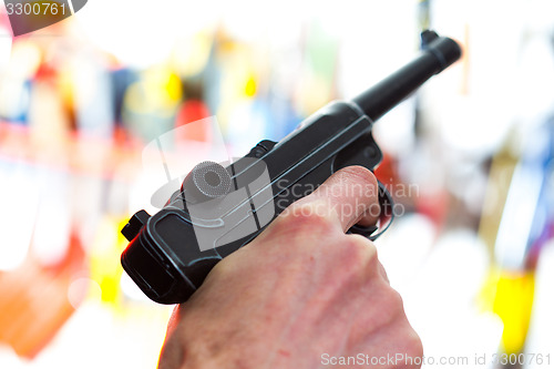 Image of Parabellum automatic pistol in a human hand