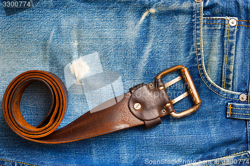 Image of vintage leather belt on old jeans