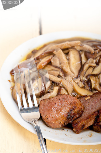 Image of venison deer game filet and wild mushrooms