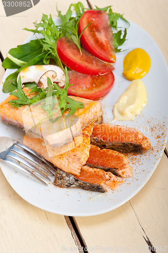 Image of grilled samon filet with vegetables salad