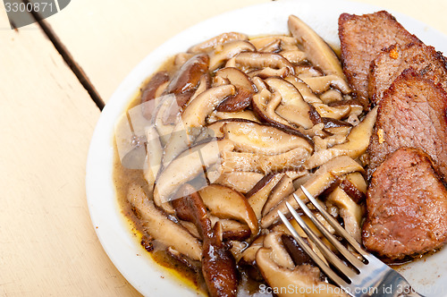 Image of venison deer game filet and wild mushrooms