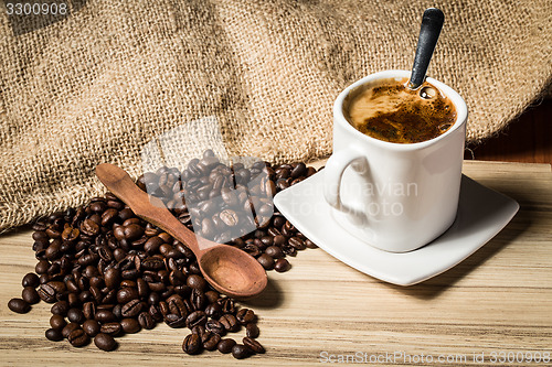 Image of pile of fresh beans, cap, and spoon