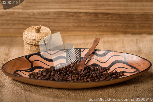 Image of pile of fresh and bio aromatic coffee beans and spoon