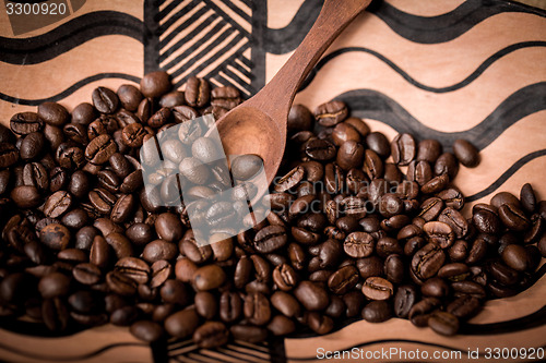 Image of pile of fresh and bio aromatic coffee beans and spoon