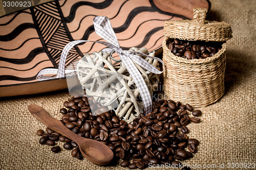 Image of pile of fresh coffee beans, heart and spoon