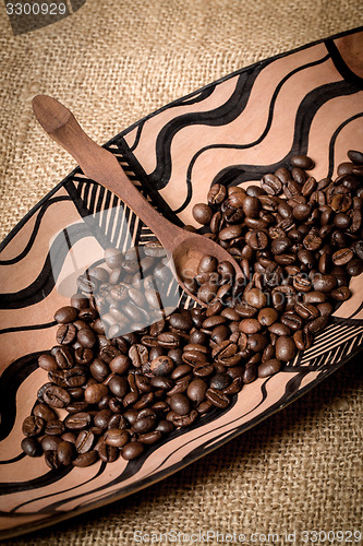 Image of pile of fresh and bio aromatic coffee beans and spoon