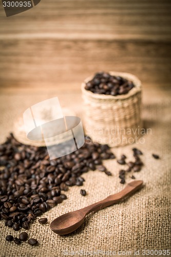 Image of pile of fresh and bio aromatic coffee beans and spoon