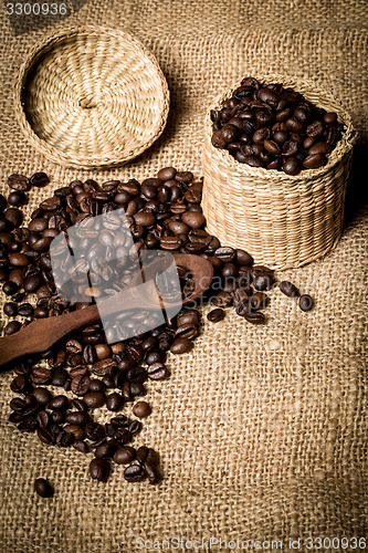 Image of pile of fresh and bio aromatic coffee beans and spoon