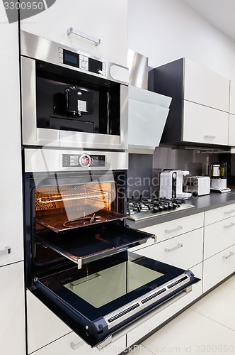 Image of Modern custom hi-tek kitchen, oven with open door