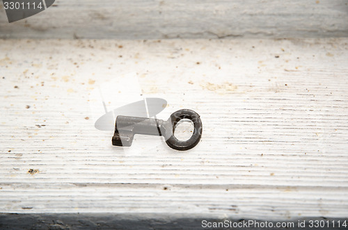 Image of Vintage key at dirty white surface