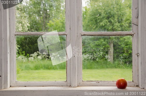 Image of Red apple at an old windowsill