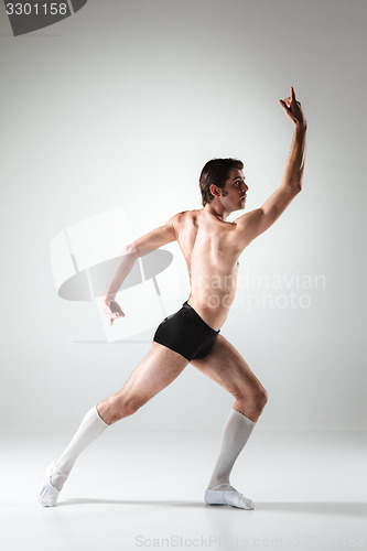 Image of The young attractive modern ballet dancer on white background