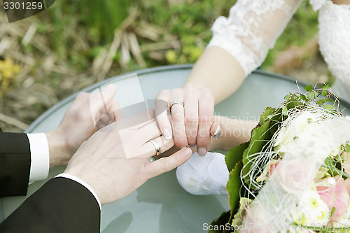 Image of Wedding rings and hands of married couple