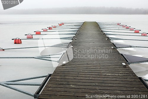 Image of empty boat park on the lake in winter under the snow