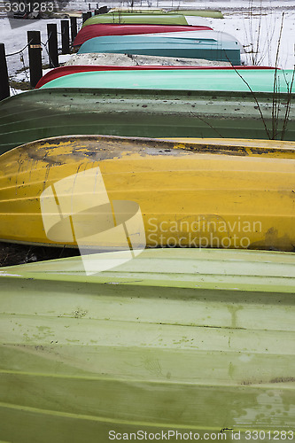 Image of colorful boats in winter on shore