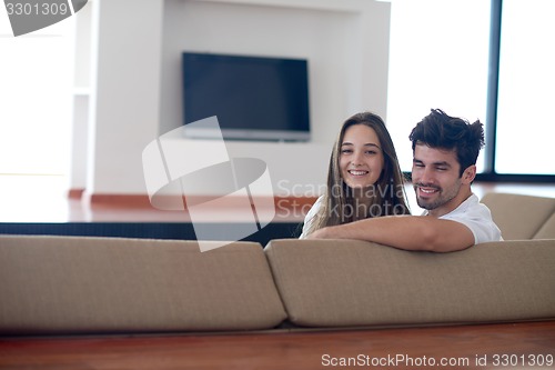 Image of relaxed young couple at home staircase