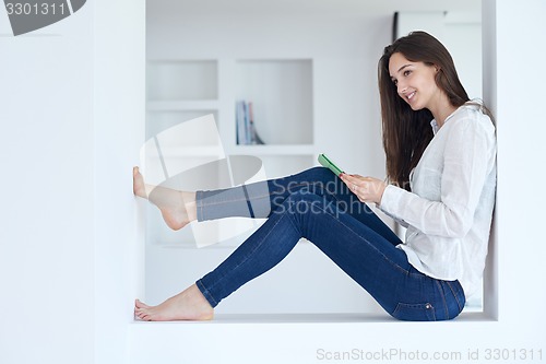 Image of woman at home using tablet