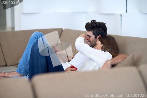 Image of couple at modern home using tablet computer