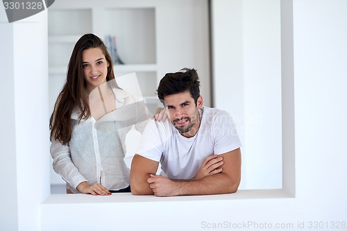 Image of relaxed young couple at home staircase