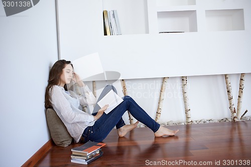 Image of relaxed young woman at home working on laptop computer